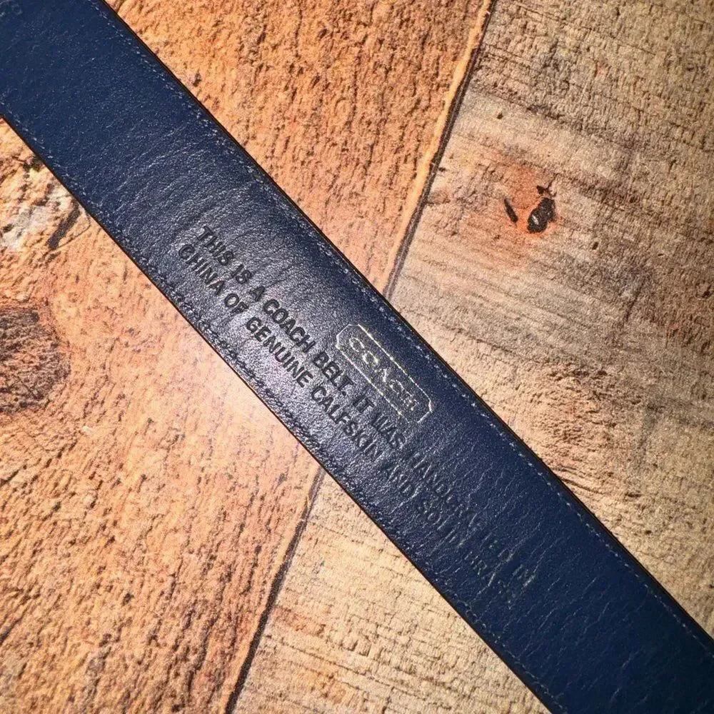 Black leather coach belt *has flaw